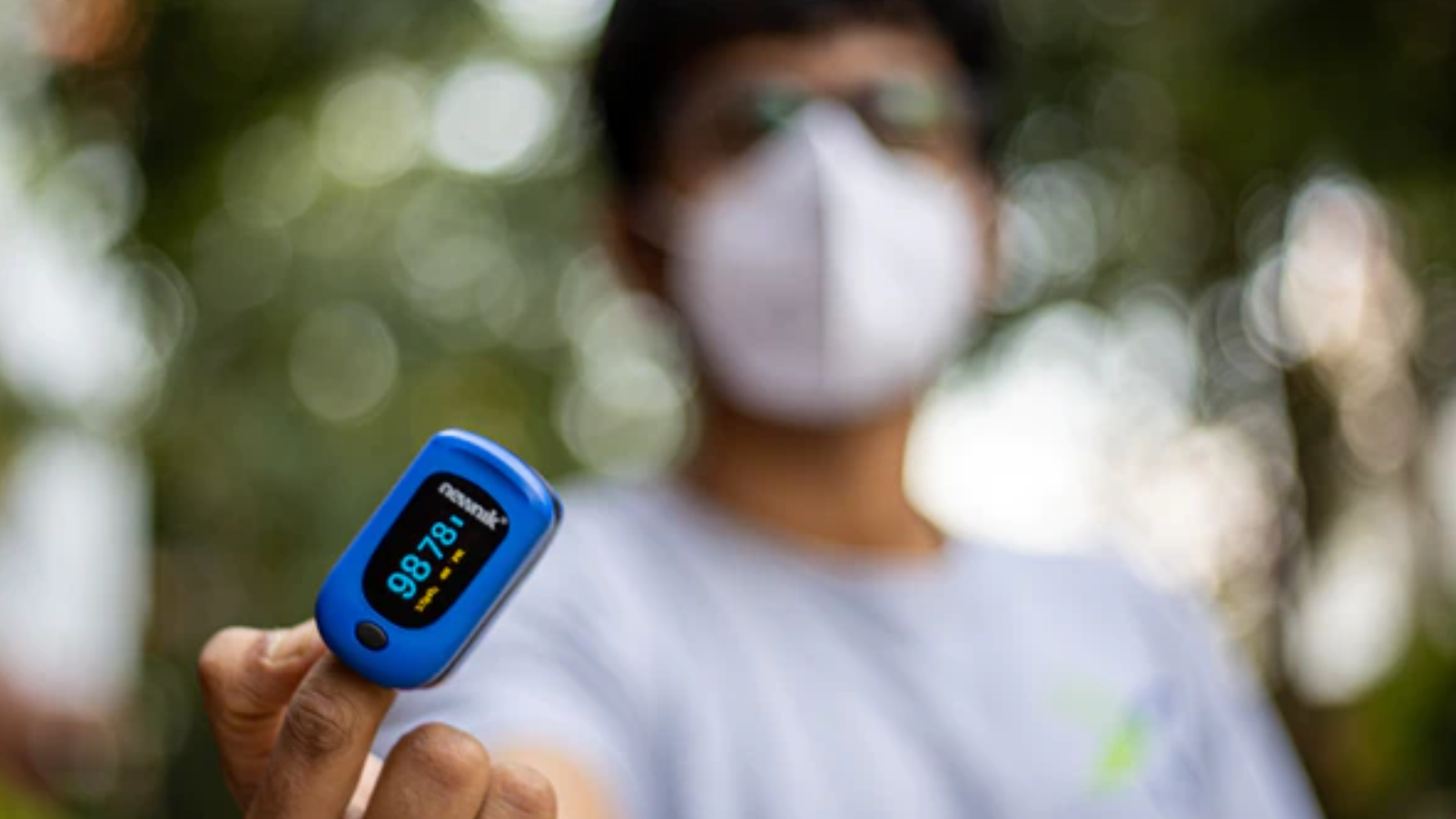 Person holding pulse oximeter