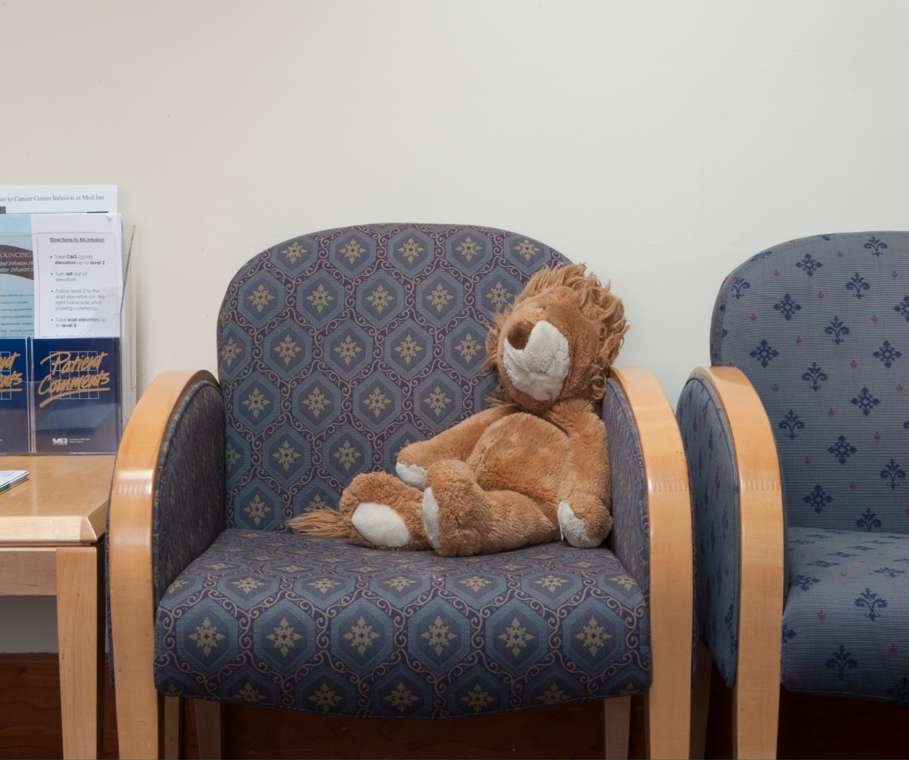 teddy bear sat on chair in waiting room
